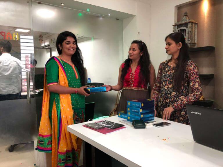 Team members exchanging a welcome gift